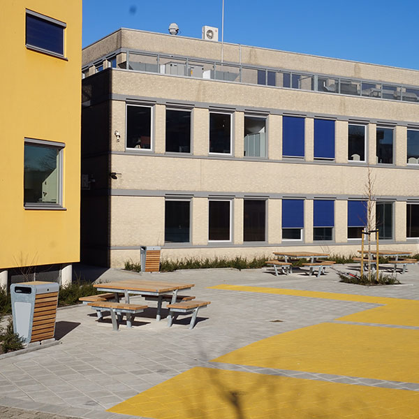 Picnic tables and litter bins at Alkwin College